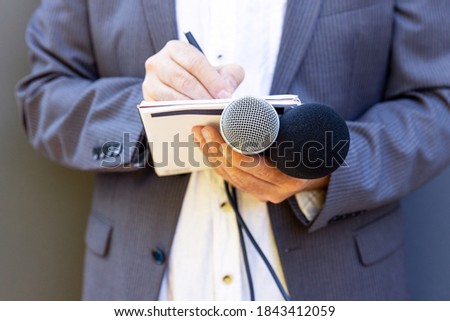 Public relation (PR) officer working at press conference or media event Royalty-Free Stock Photo #1843412059