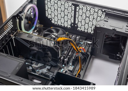 Studio shot of black Gaming desktop pc with rgb lights and visible components. Isolated on white background. Royalty-Free Stock Photo #1843415989