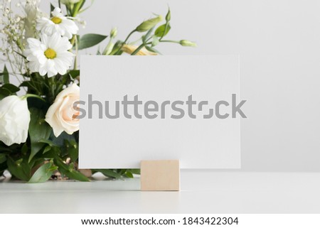 Wedding table number card mockup with a floral arrangement. Royalty-Free Stock Photo #1843422304