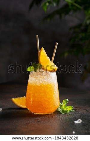 Fresh cold cocktial with orange, crushed ice and mint, selective focus image and bar concept Royalty-Free Stock Photo #1843432828