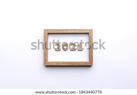 New year 2021. Template for New Year's greetings. 2021 text in a wooden frame on a white background. A lot of copy space