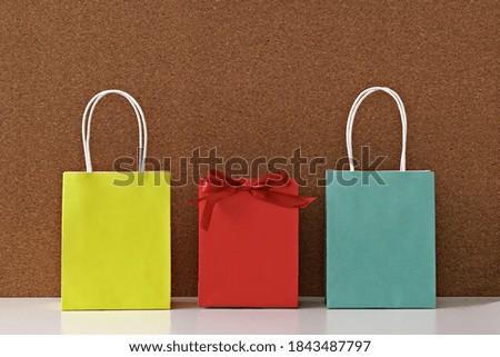 Gift paper bags on a cork background. Copy space, flat lay, mock up, top view
