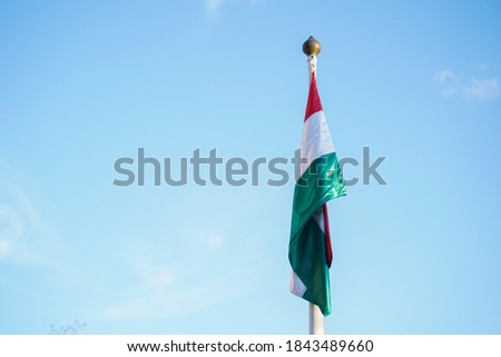 Hungary national flag on blue sky background. The flag of the Republic of Hungary. Europe Hungary