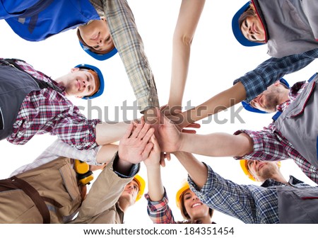 Large group of construction worker stacking hands. Isolated on white Royalty-Free Stock Photo #184351454
