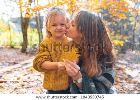 daughter and her mother in the autumn season in park
