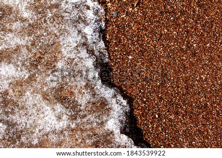 Sea background. Waves on the background of pebbles. Seashore.