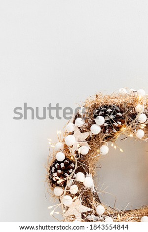 Top view of traditional Christmas wreath with copy space over neutral background. Winter holidays and Christmas celebration concept, flat lay, copy space
