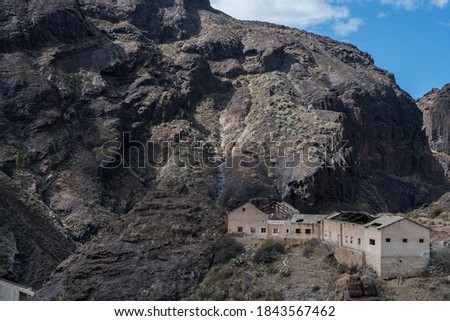 Abandoned building in rocky area Royalty-Free Stock Photo #1843567462