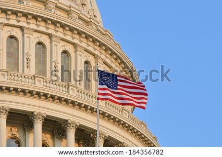 The U.S. Capitol building dome detail and waving American flag - Washington DC 