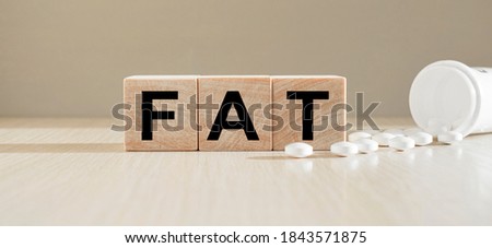 Wooden cubes with the inscription with a bright yellow background and scattered tablets. Medical concept