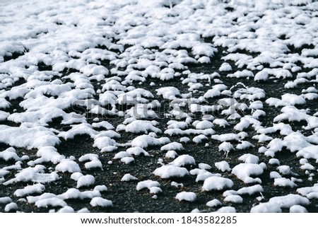 Stones and rocks filled with pure white snow from a recent snowfall. Background and texture of winter.