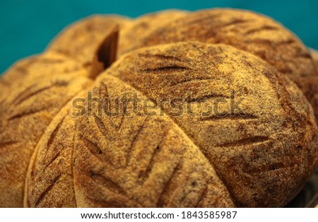 Homemade pastry, fresh pumpkin-shaped bread, background for Thanksgiving and Halloween.