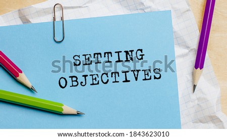Setting Objectives text written on a paper with pencils in office