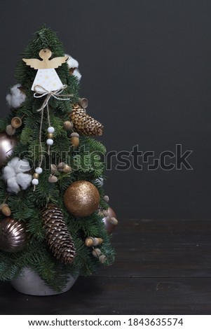 Christmas tree made of fresh Nobilis spruce, decorated with festive ornaments and pine cones