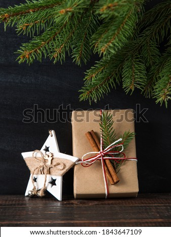 Christmas tree branches, gift and decoration on a chalkboard background. The concept of a merry Christmas. Copy space.