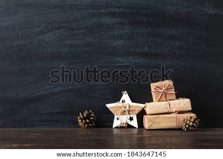 Gift and handmade star decoration against a chalkboard. The concept of a merry Christmas. Copy space.