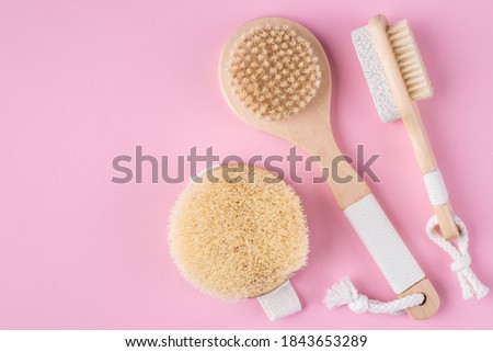 Flat lay top above overhead close up view photo of massage brushes isolated on pastel color background with empty blank space