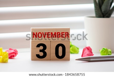 Wooden calendar November 30 on a white background close up.