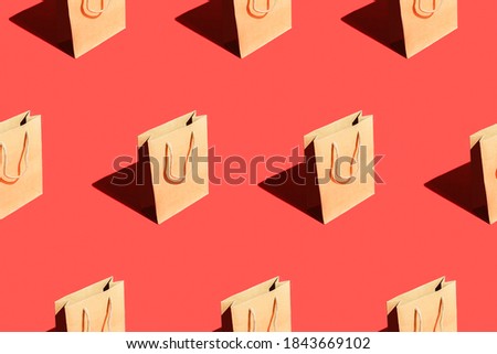 Seamless pattern from craft bags on a red background. Royalty-Free Stock Photo #1843669102