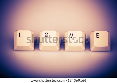 Word love formed with computer keyboard keys on white background with shadow