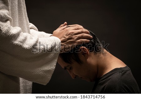 Jesus Christ giving absolution of their sins during a dark night. Royalty-Free Stock Photo #1843714756