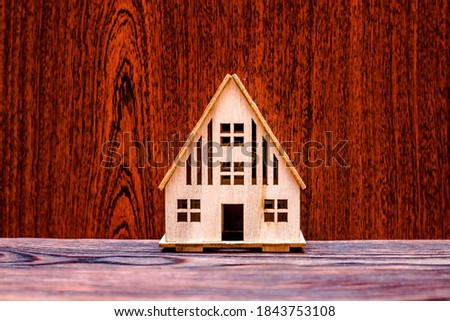House symbol on a brown wooden background