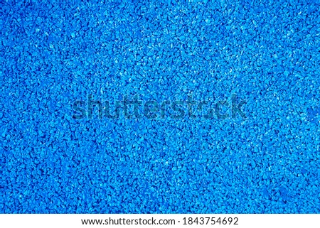 Texture of small pebble blue stones. Abstract background in grunge style. Template for graphic design, wallpaper, covers. Copy space for text