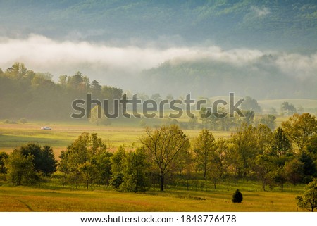 Morning mist over Cades Cove in the Great Smoky Mountains National Park Royalty-Free Stock Photo #1843776478