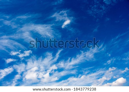 Fluffy white cumulus clouds with some cumulostratus and cirrus formations on a late spring afternoon are contrasted against the Australian sky creating a fascinating cloud scape.