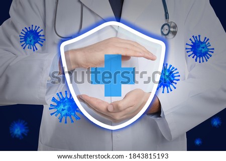 Immunologist and shield with cross as symbol of virus protection, closeup Royalty-Free Stock Photo #1843815193