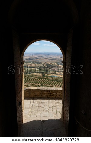 views of the mountainous landscape from inside the dark medieval castle. through the front door. receiver