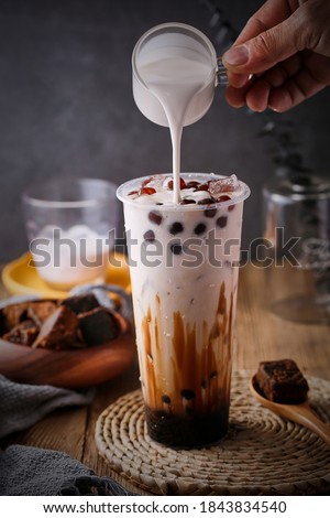 Black bubble milk tea advertising photography Royalty-Free Stock Photo #1843834540