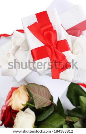 Beautiful gifts with red ribbons and flowers, close up