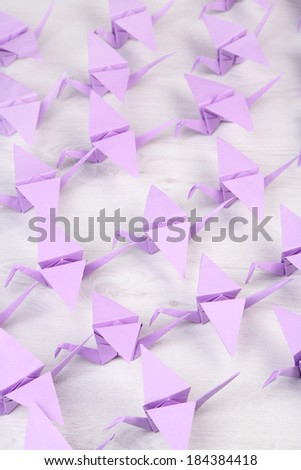 Origami cranes on wooden background