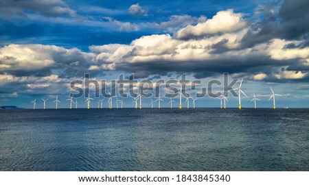 Offshore Wind Turbine in a Windfarm under construction off the England Coast Royalty-Free Stock Photo #1843845340