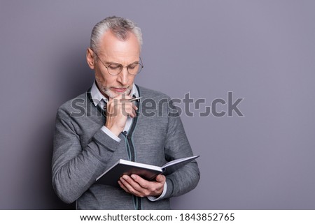 Portrait of his he nice-looking attractive calm focused intellectual business shark wearing casual formal-wear thinking about notes essay isolated over gray pastel background Royalty-Free Stock Photo #1843852765