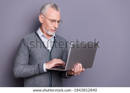 Portrait of his he nice attractive focused banker business shark wearing casual formal-wear using netbook e-commerce isolated over gray pastel background Royalty-Free Stock Photo #1843852840
