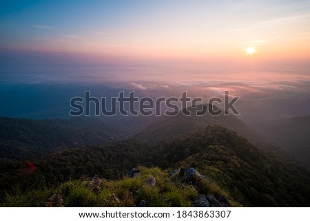 Beautiful sunrise over the mountain range and sea clouds in Doi Luang National Park, Payao, Thailand.