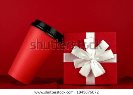 Happy New year 2021 christmas shopping. Gift box and coffee cup on red background, Monochrome.