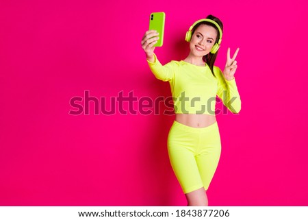 Portrait of her she nice attractive pretty charming cheerful cheery glad girl listening music taking selfie showing v-sign isolated bright vivid shine vibrant pink fuchsia color background