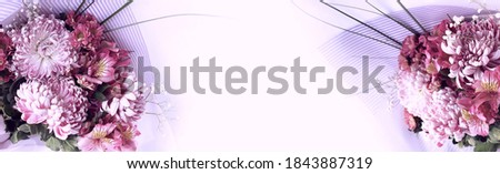 Delicate lilac chrysanthemums on a light background. Floral arrangement in pastel colors. Background for a greeting card.