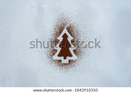 Christmas tree made from cocoa powder on a gray background. Design, abstract.
