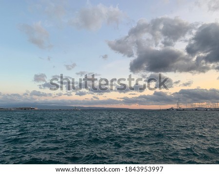A cloudy, orange sunset over the Adriatic Sea in Split, Croatia. 
