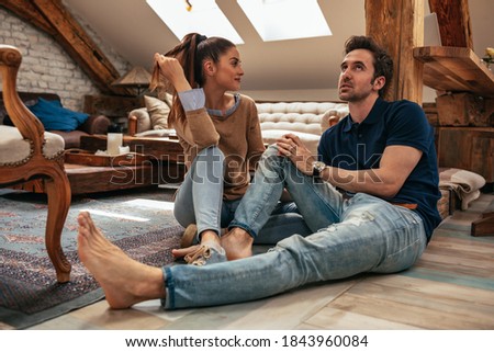 Lovely young couple enjoying together at home Royalty-Free Stock Photo #1843960084