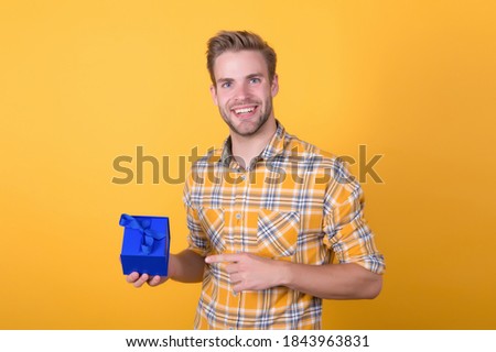 try this one. sale and discount concept. boxing day. happy birthday to you. surprise for holiday. handsome unshaven man hold present box. young macho with valentines day gift. male go shopping.