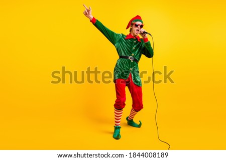 Full length body size view of his he nice attractive cool talented funny guy elf mc pj dj singing hit having fun festal day isolated over bright vivid shine vibrant yellow color background