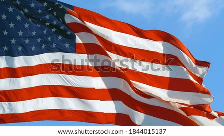 American flag USA Close Up waving background texture. Close up of USA flag waving in wind on a bright sunny day.