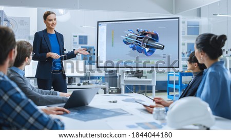 Confident Female Automotive Engineer Reports to Diverse Team of Specialists, Businesspeople and Investors Sitting at the Conference Table, She Use Interactive TV, Analyze Sustainable Energy Engine