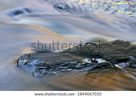Abstract landscape of the Presque Isle River rapids captured with motion blur, Porcupine Mountains Wilderness State Park, Michigan's Upper Peninsula, USA
