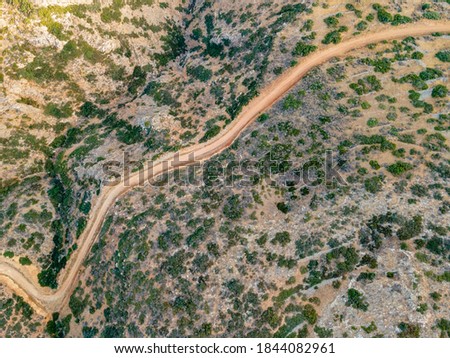 Aerial top view by drone of cretan landscape with road.